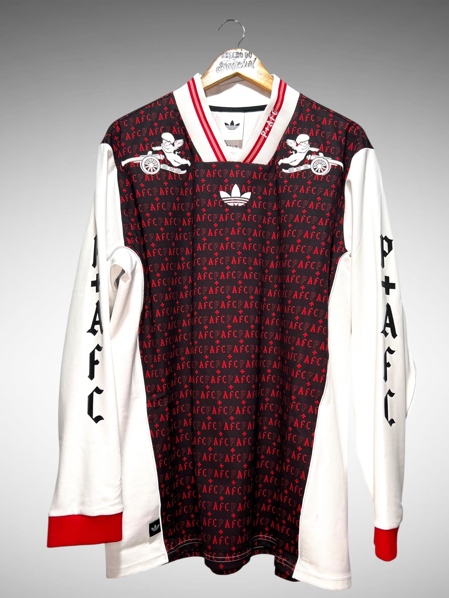 Arsenal 2026 Camisa Places + Faces Lifestyler Tam G Mangas Longas.